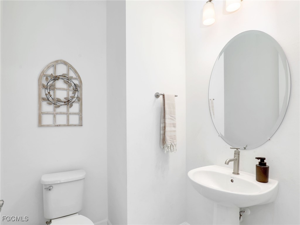 20179 Napa Loop Estero, FL 33928 - Photo 35 of 49 a bathroom with a toilet and a sink