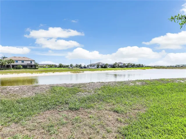a view of a lake with houses in the back
