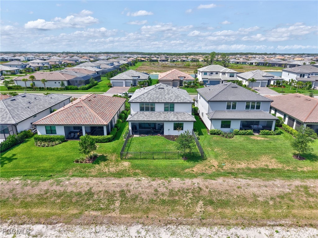 20179 Napa Loop Estero, FL 33928 - Photo 45 of 49 a view of a big yard next to a large building
