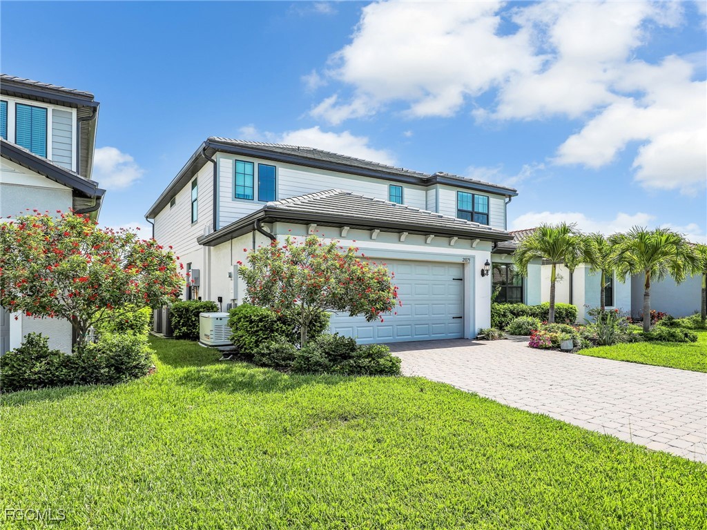 20179 Napa Loop Estero, FL 33928 - Photo 48 of 49 a front view of a house with a garden and yard