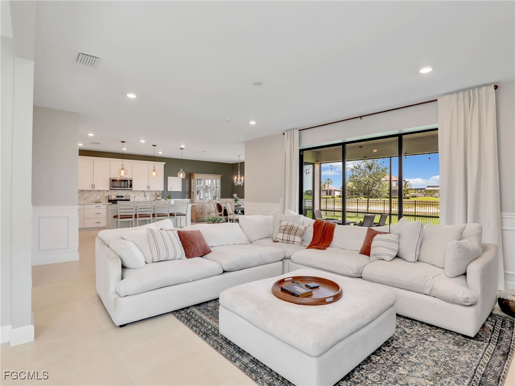 20179 Napa Loop Estero, FL 33928 - Photo 9 of 49 a living room with furniture and a large window
