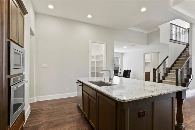 a kitchen with a stove a refrigerator and a sink