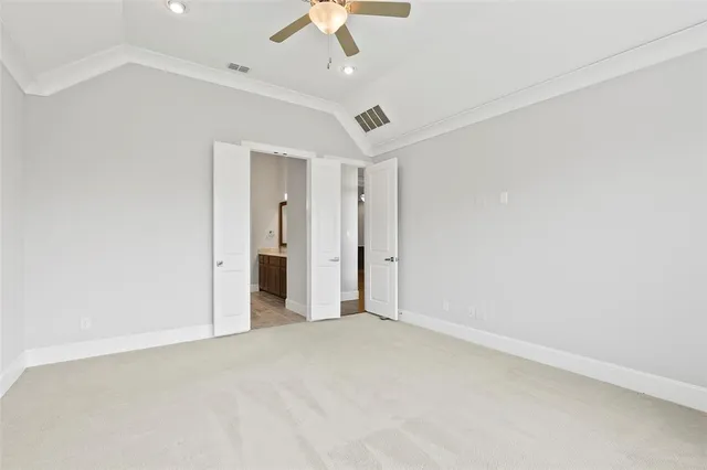 an empty room with a ceiling fan and a window