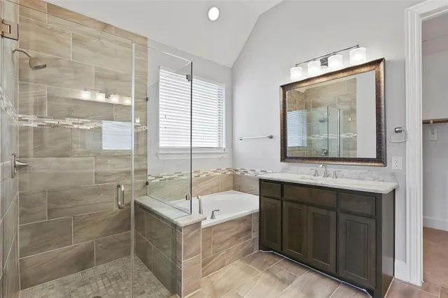 a bathroom with a tub sink and mirror