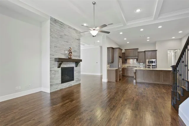 a view of kitchen with refrigerator stove and wooden floor