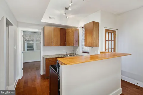 a room with wooden floor and window