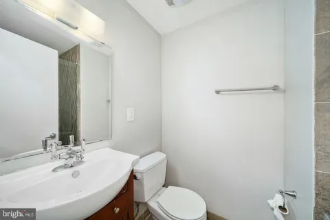 a bathroom with a sink toilet and mirror
