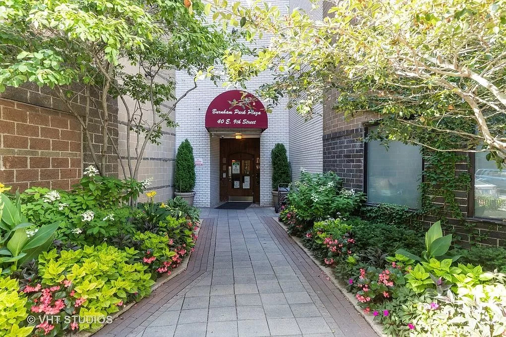 a front view of a house with a yard and flowers