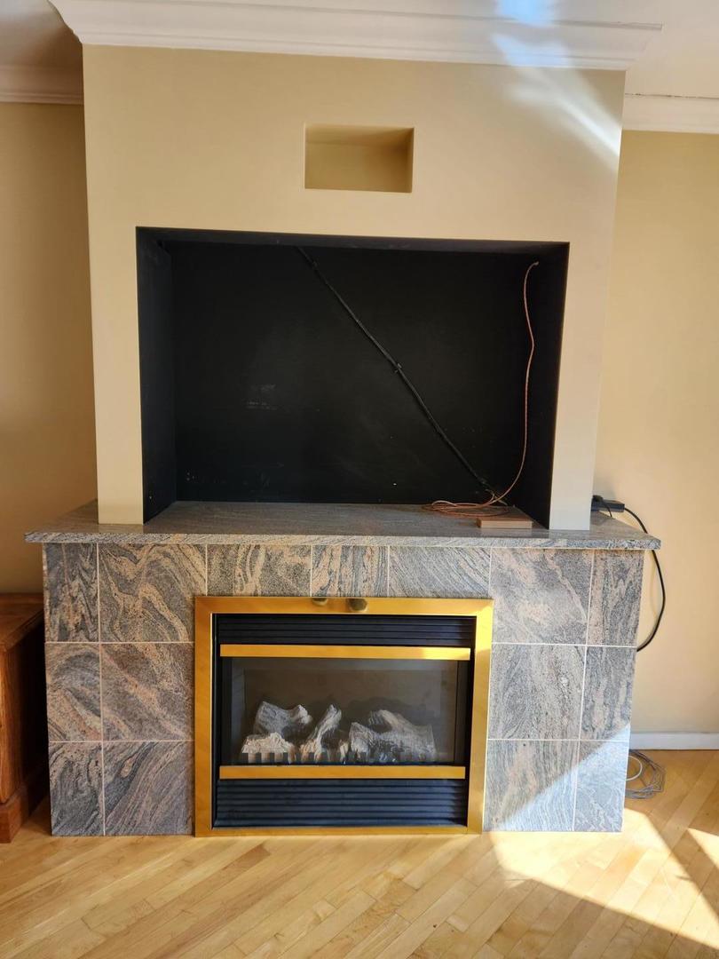 40 East 9th Street, Unit 1604 Chicago, IL 60605 - Photo 11 of 25 a fireplace with a clock on wall