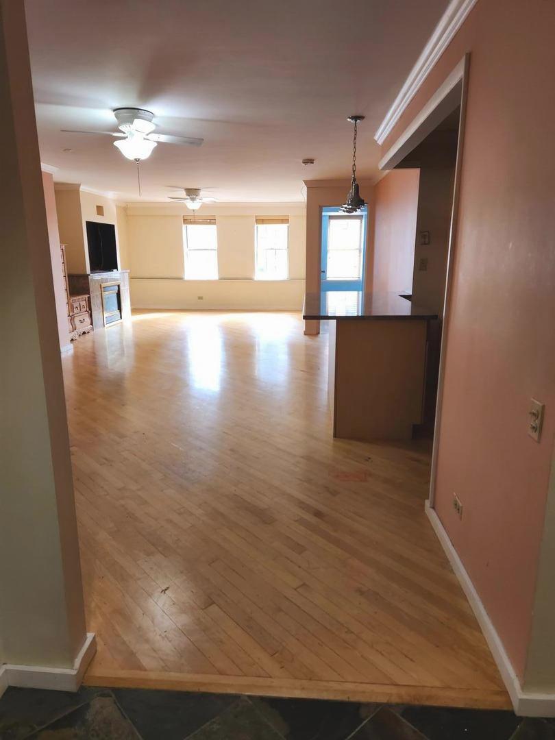 40 East 9th Street, Unit 1604 Chicago, IL 60605 - Photo 6 of 25 a view of a living room with hardwood floor
