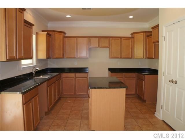 417 Rook Road Charlotte, NC 28216 - Photo 4 of 9 a kitchen with stainless steel appliances granite countertop a sink stove and cabinets