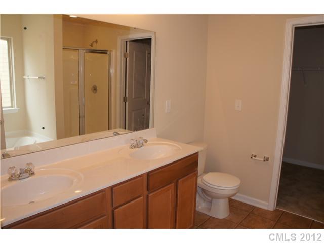 417 Rook Road Charlotte, NC 28216 - Photo 9 of 9 a bathroom with a sink a toilet and a mirror