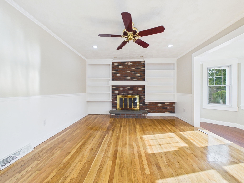 786 Wildwood Road New Bedford, MA 02745 - Photo 5 of 39 a view of an empty room with wooden floor and a window
