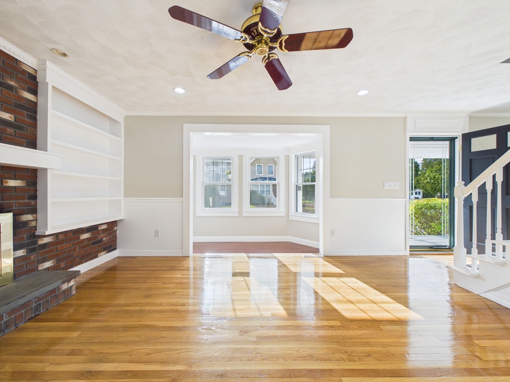 786 Wildwood Road New Bedford, MA 02745 - Photo 6 of 39 a view of an empty room with window and wooden floor