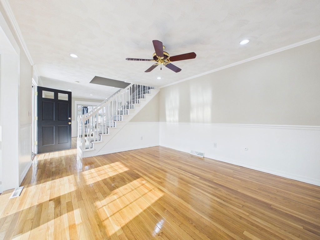 786 Wildwood Road New Bedford, MA 02745 - Photo 7 of 39 a view of a livingroom with a chandelier fan and wooden floor