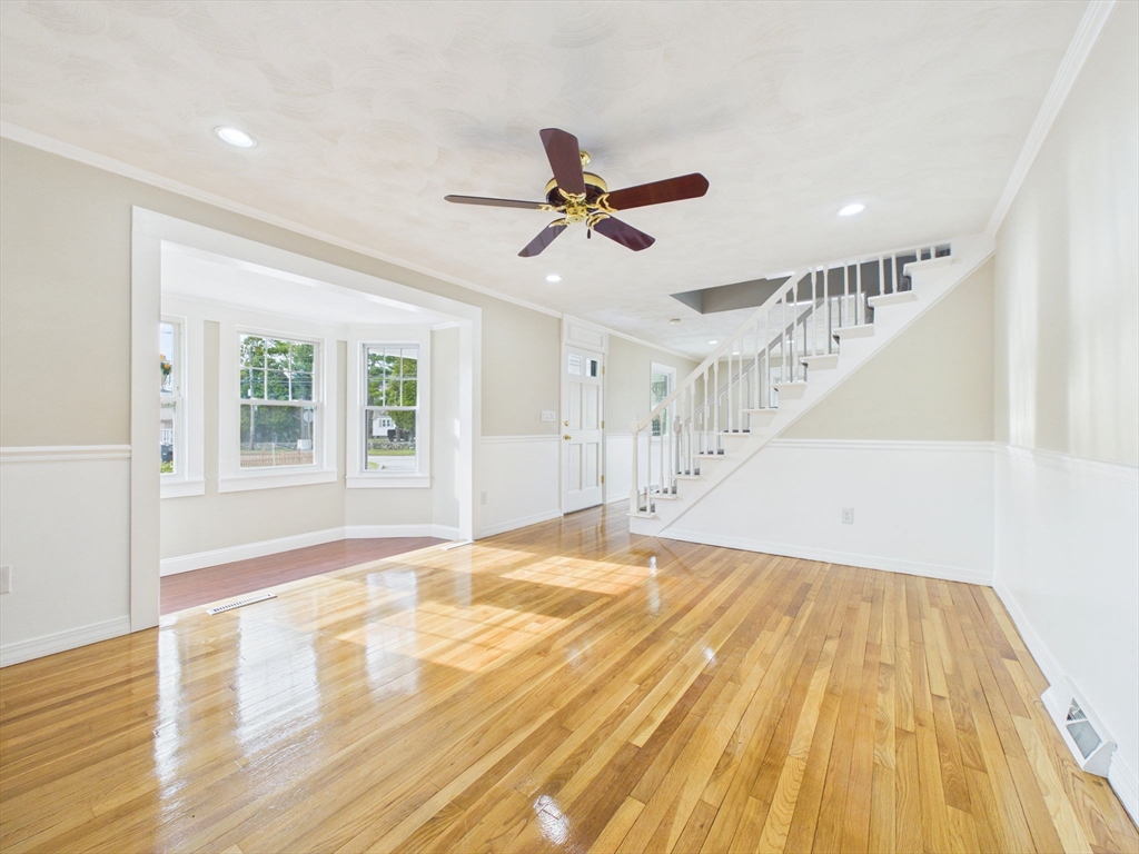 786 Wildwood Road New Bedford, MA 02745 - Photo 8 of 39 a view of empty room with wooden floor and fan