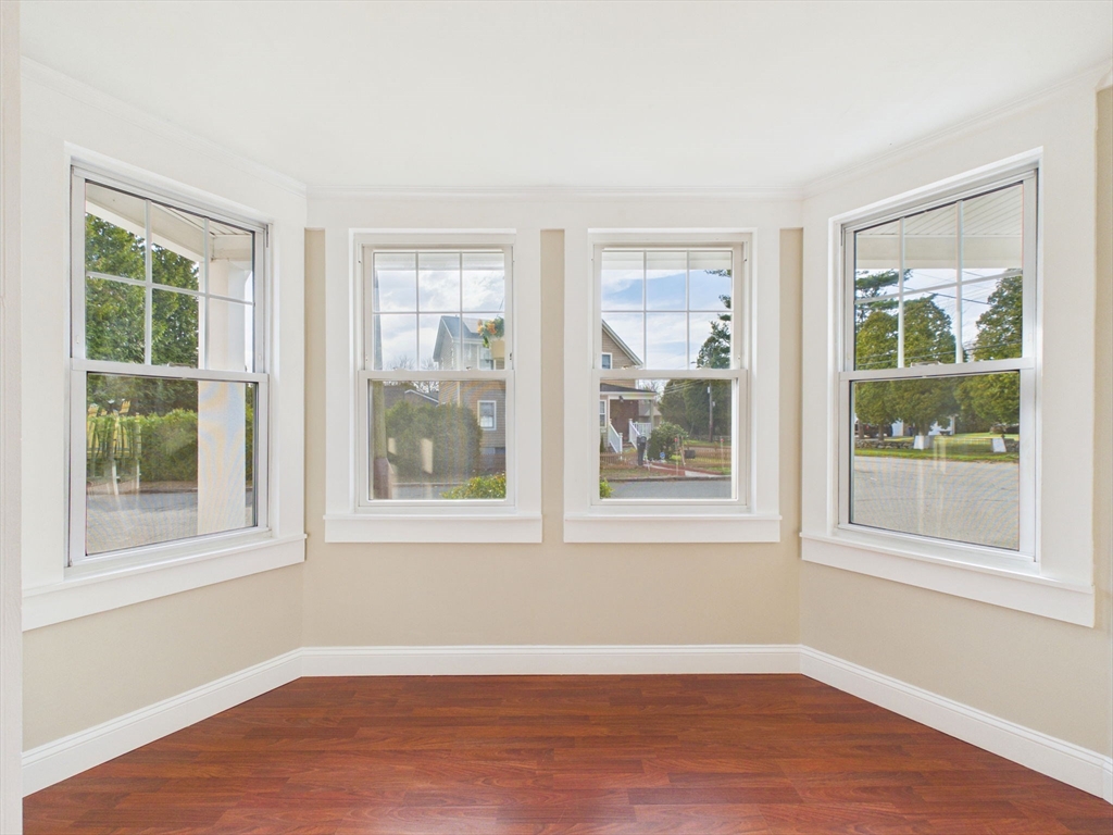 786 Wildwood Road New Bedford, MA 02745 - Photo 9 of 39 a view of an empty room with wooden floor and a window