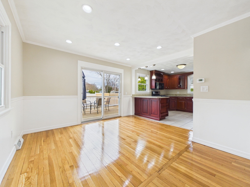 786 Wildwood Road New Bedford, MA 02745 - Photo 10 of 39 a large kitchen with stainless steel appliances a large counter top a stove and a wooden floors