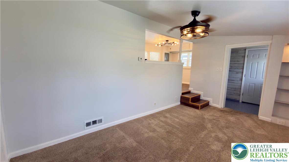246 Poplar Street Bath, PA 18014 - Photo 10 of 34 A well-lit interior features a modern ceiling fan and plush carpeted flooring, creating a comfortable ambiance.