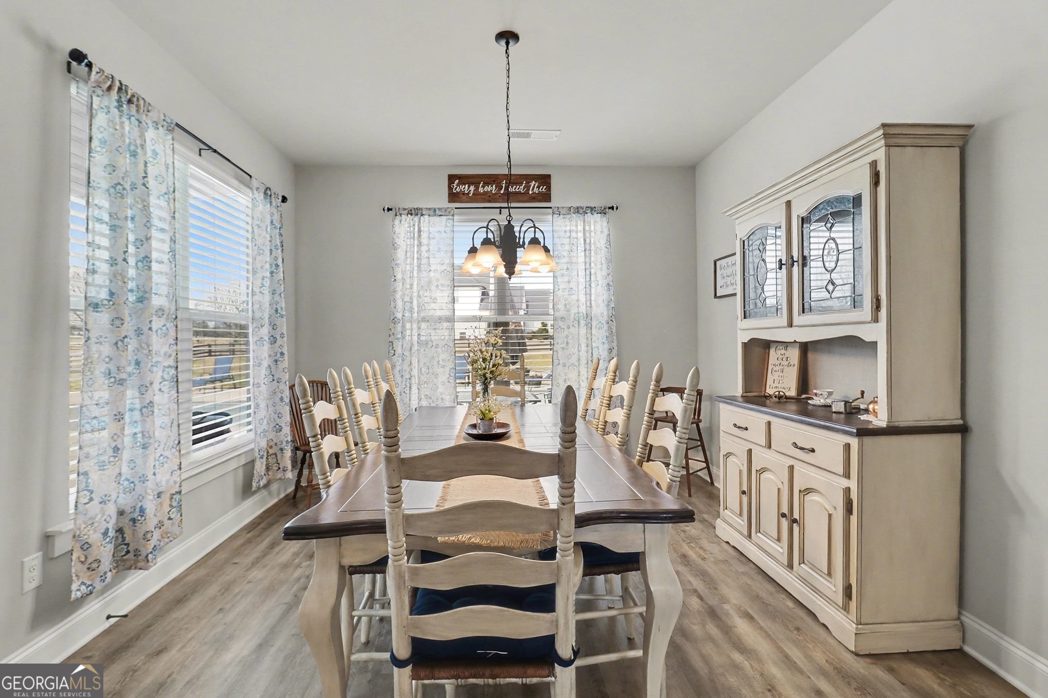 9 Union Street Newnan, GA 30263 - Photo 16 of 31 a dining room with furniture a chandelier and wooden floor