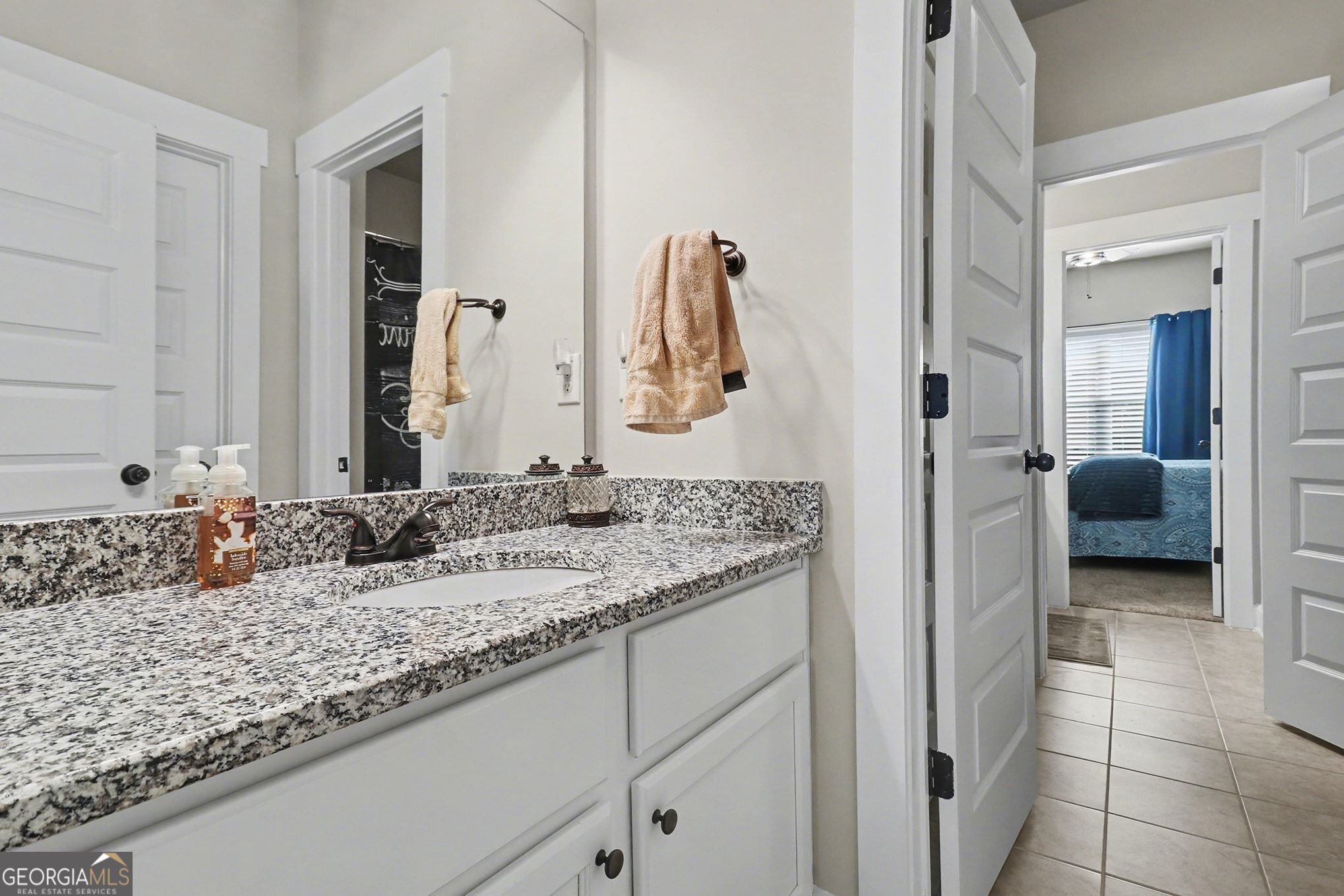 9 Union Street Newnan, GA 30263 - Photo 29 of 31 a bathroom with a granite countertop sink and a mirror