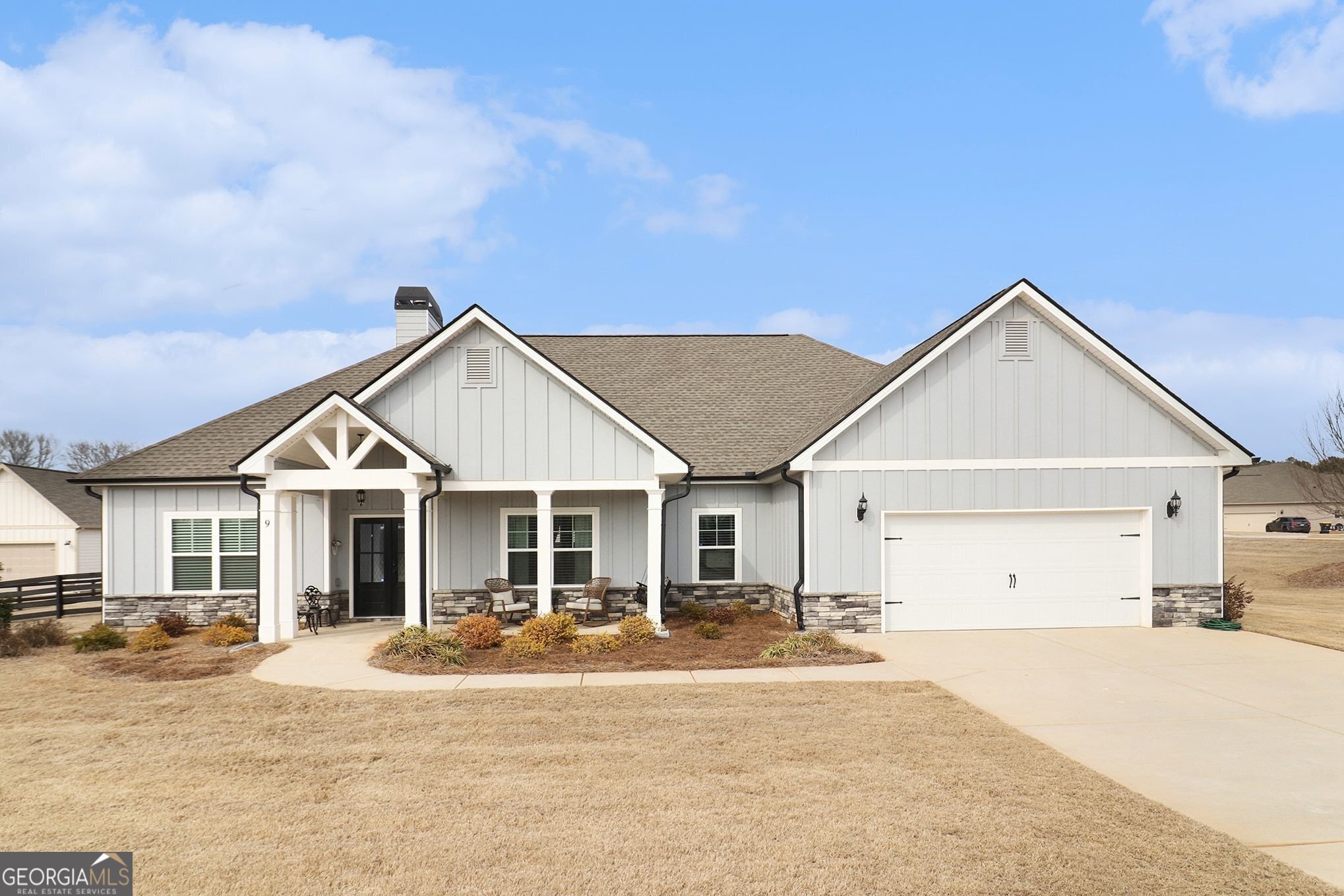 9 Union Street Newnan, GA 30263 - Photo 3 of 31 a front view of a house with a yard and garage