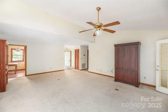 a view of an empty room with a ceiling fan
