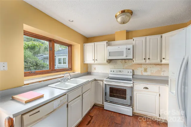 a kitchen with a stove a sink and a window