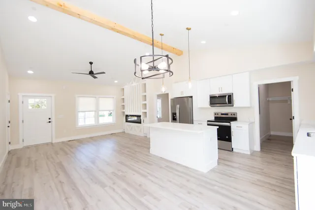 an aerial view of water body with boats and residential houses with outdoor space