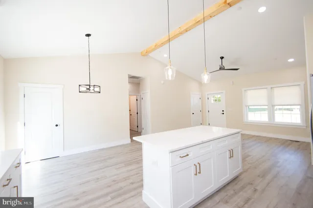 a view of a kitchen with stainless steel appliances a refrigerator sink and microwave