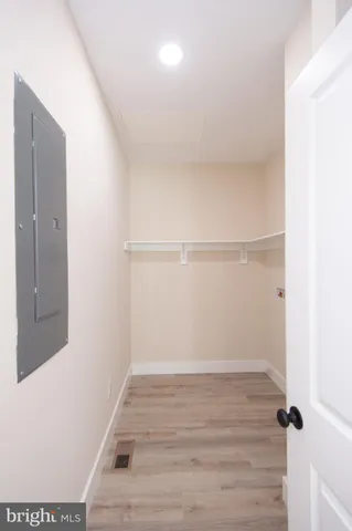 a kitchen with white cabinets and a window