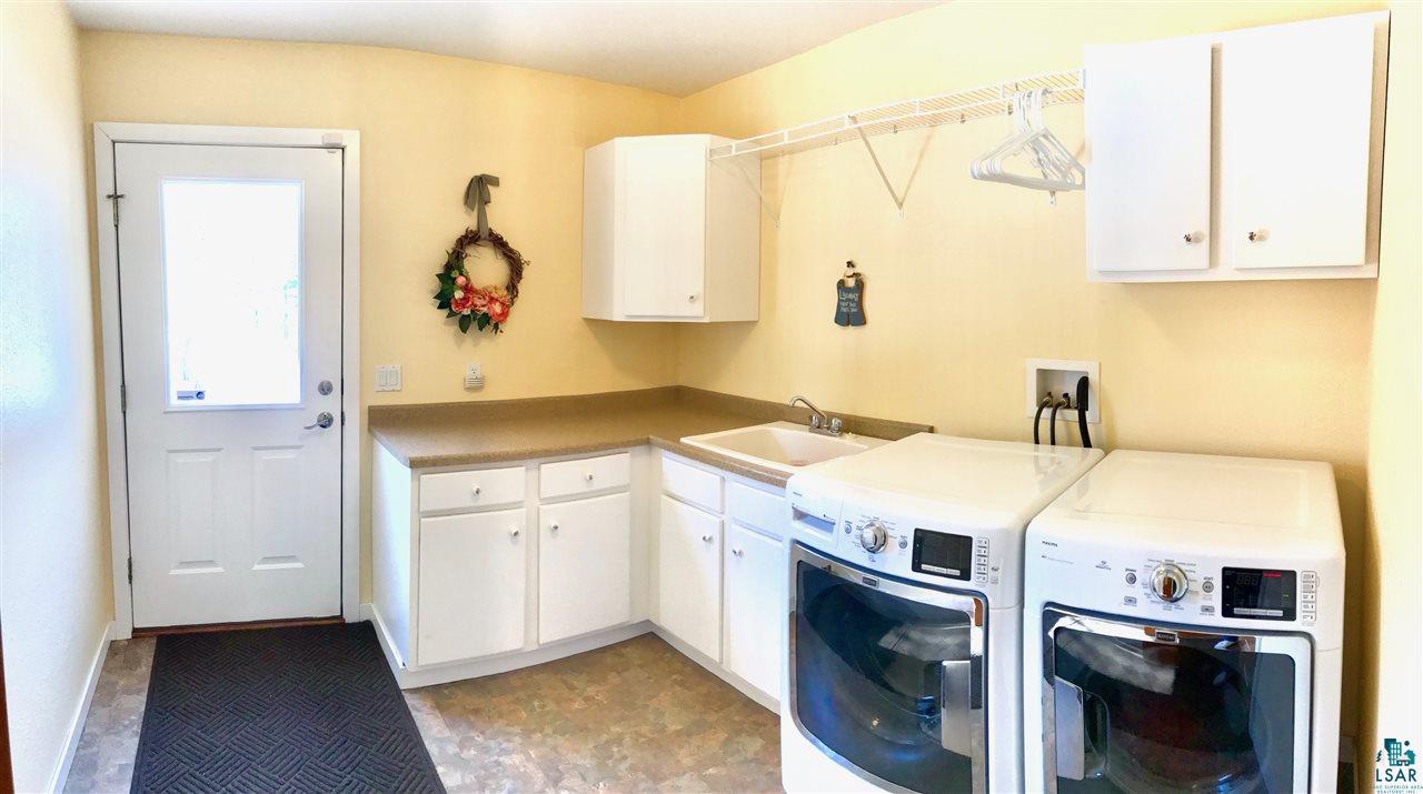 5048 Independence Road Saginaw, MN 55779 - Photo 19 of 34 LAUNDRY ROOM GREAT FUNCTION LOTS OF CABINETS EXTERIOR ENTRY