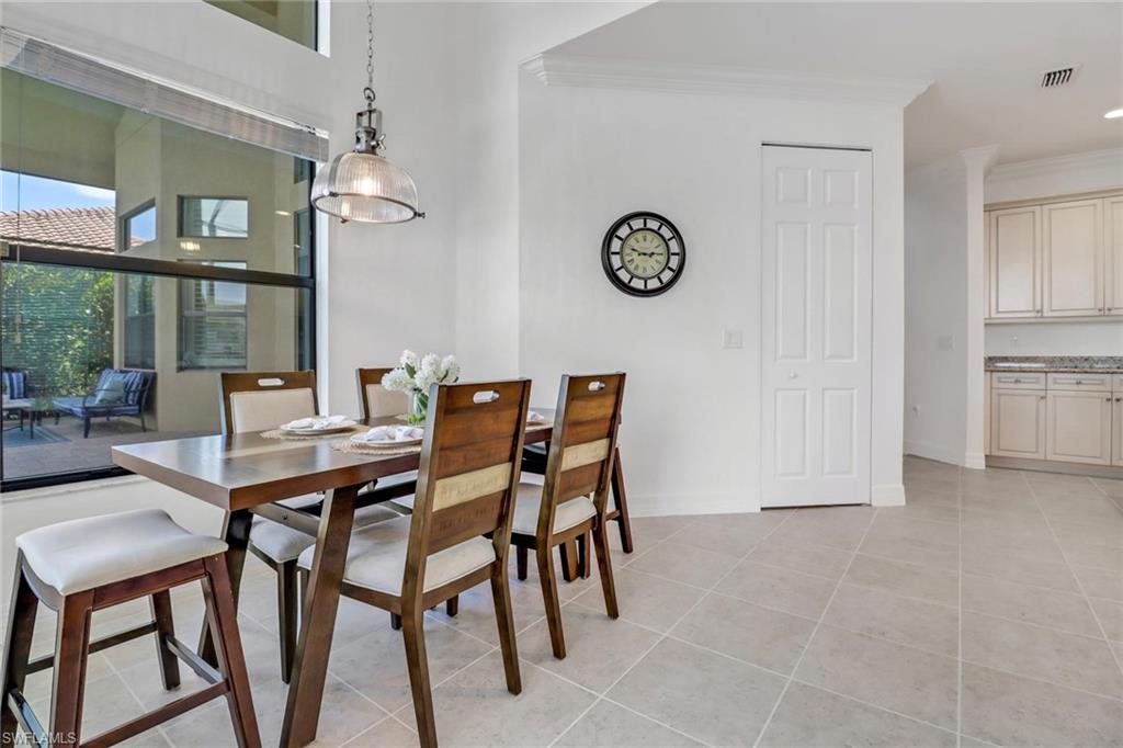 3260 Atlantic Circle Naples, FL 34119 - Photo 15 of 50 a dining room with furniture and window