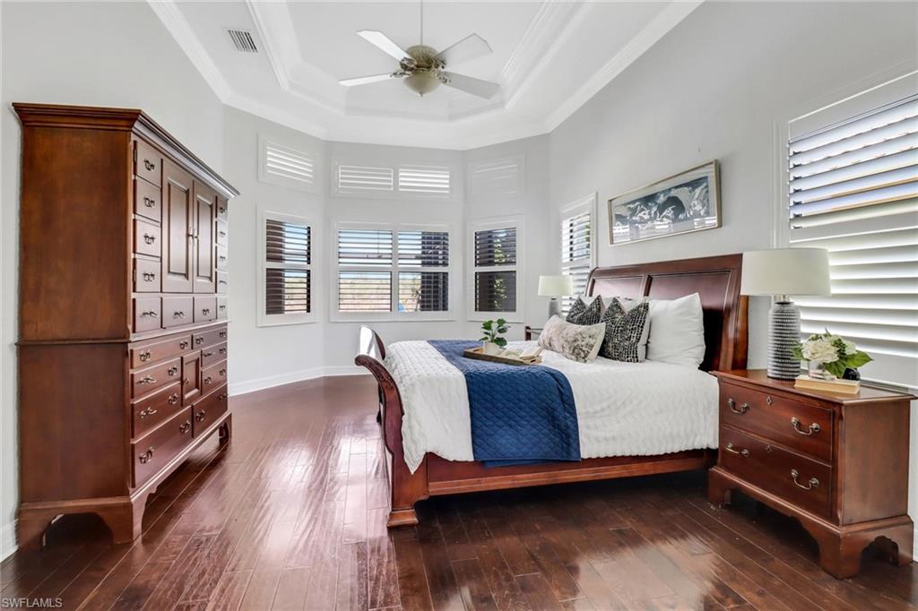 3260 Atlantic Circle Naples, FL 34119 - Photo 16 of 50 a bedroom with a bed and wooden floor