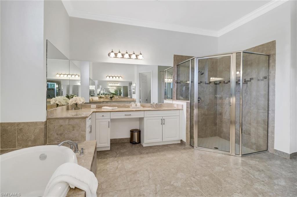 3260 Atlantic Circle Naples, FL 34119 - Photo 19 of 50 a bathroom with a bathtub shower sink and toilet