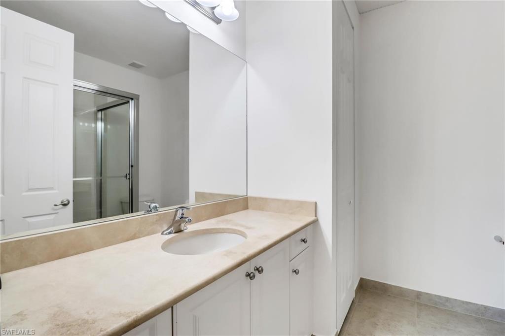 3260 Atlantic Circle Naples, FL 34119 - Photo 27 of 50 a bathroom with a sink and a mirror