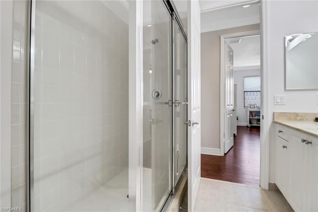 3260 Atlantic Circle Naples, FL 34119 - Photo 28 of 50 a bathroom with a walk in closet and a mirror
