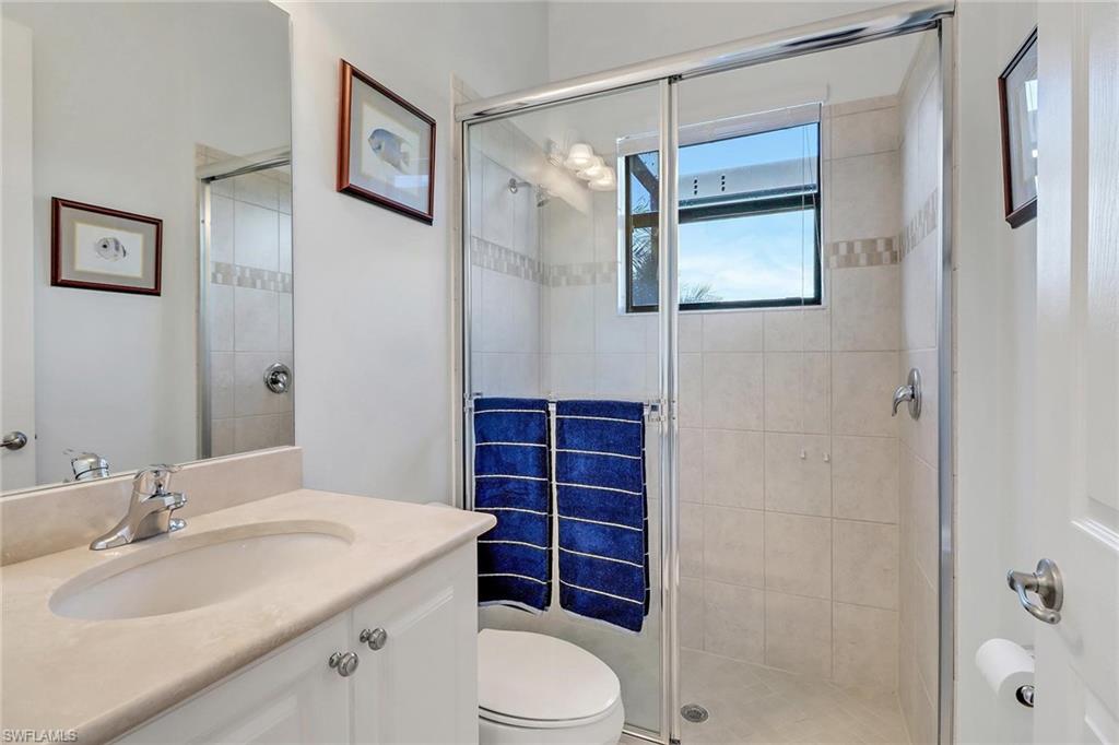 3260 Atlantic Circle Naples, FL 34119 - Photo 30 of 50 a bathroom with a sink a toilet and shower
