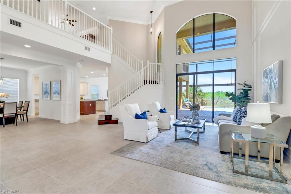 3260 Atlantic Circle Naples, FL 34119 - Photo 3 of 50 a living room with furniture and a large window