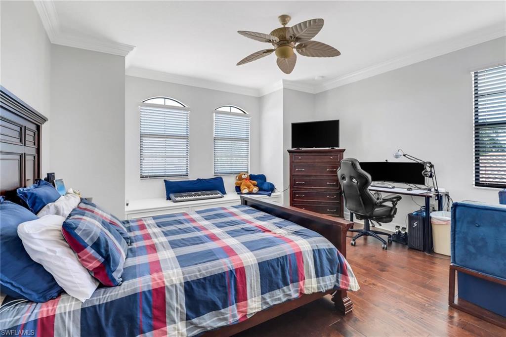 3260 Atlantic Circle Naples, FL 34119 - Photo 31 of 50 a bedroom with a bed and wooden floor