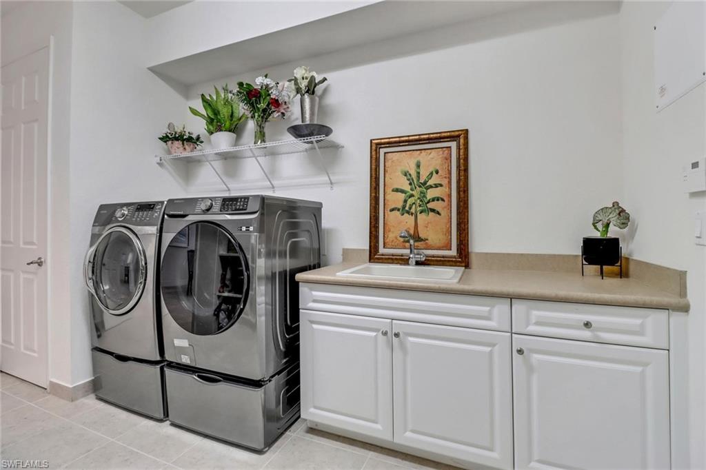 3260 Atlantic Circle Naples, FL 34119 - Photo 34 of 50 a utility room with sink dryer and washer
