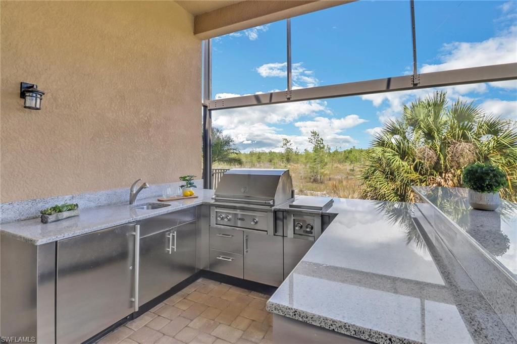3260 Atlantic Circle Naples, FL 34119 - Photo 36 of 50 a kitchen with stainless steel appliances kitchen island granite countertop a sink and cabinets