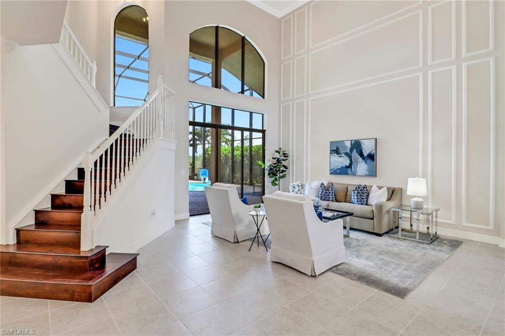 3260 Atlantic Circle Naples, FL 34119 - Photo 4 of 50 a living room with furniture and stairs