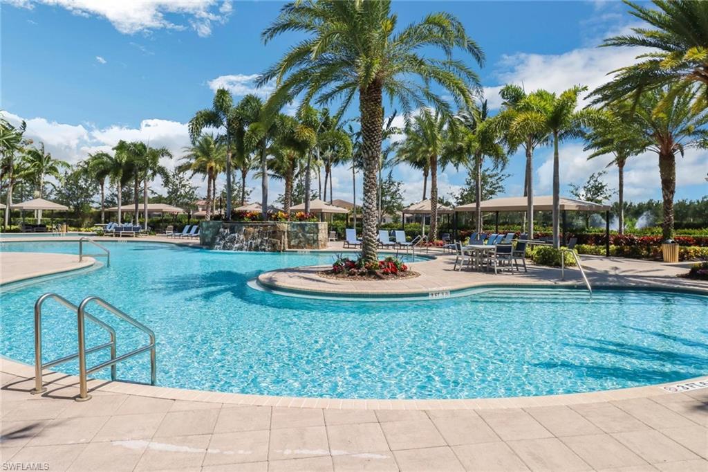 3260 Atlantic Circle Naples, FL 34119 - Photo 43 of 50 a swimming pool with outdoor seating and yard