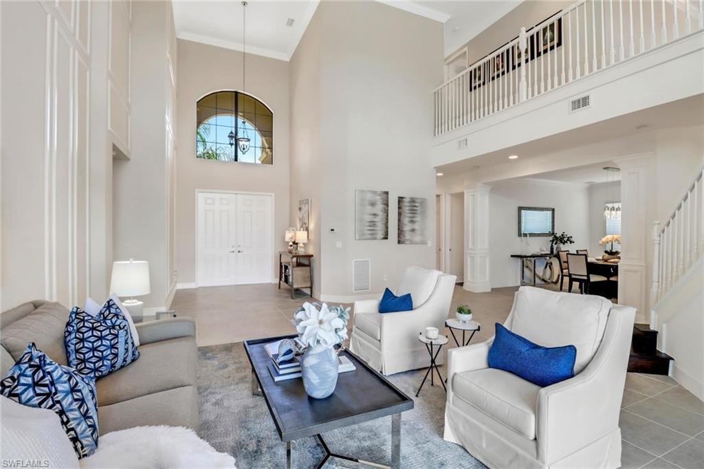 3260 Atlantic Circle Naples, FL 34119 - Photo 5 of 50 a living room with furniture and painting on the wall