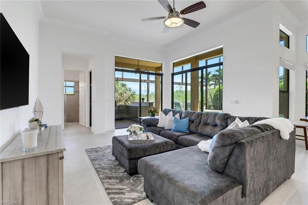 3260 Atlantic Circle Naples, FL 34119 - Photo 6 of 50 a living room with furniture and a flat screen tv