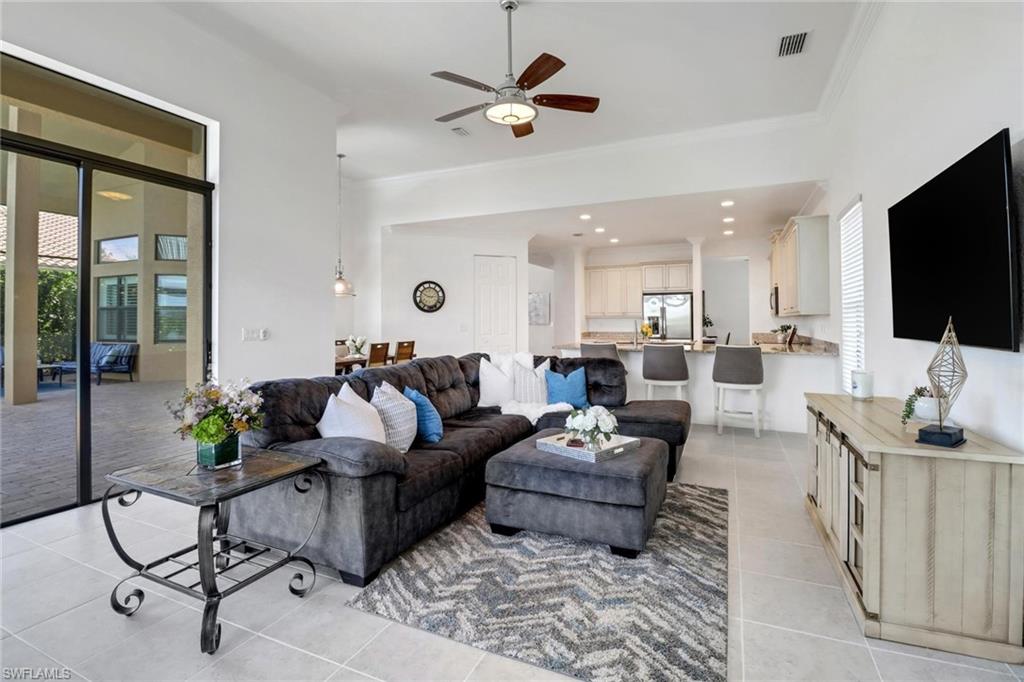 3260 Atlantic Circle Naples, FL 34119 - Photo 7 of 50 a living room with furniture and a flat screen tv