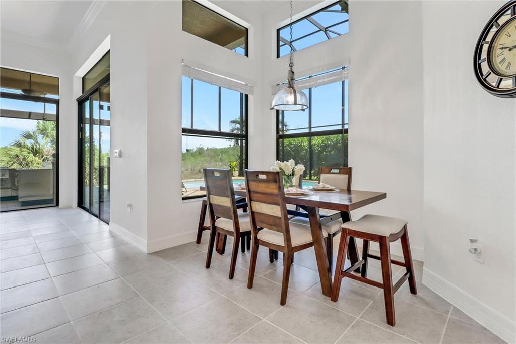 3260 Atlantic Circle Naples, FL 34119 - Photo 8 of 50 a view of a dining room with furniture and a potted plant