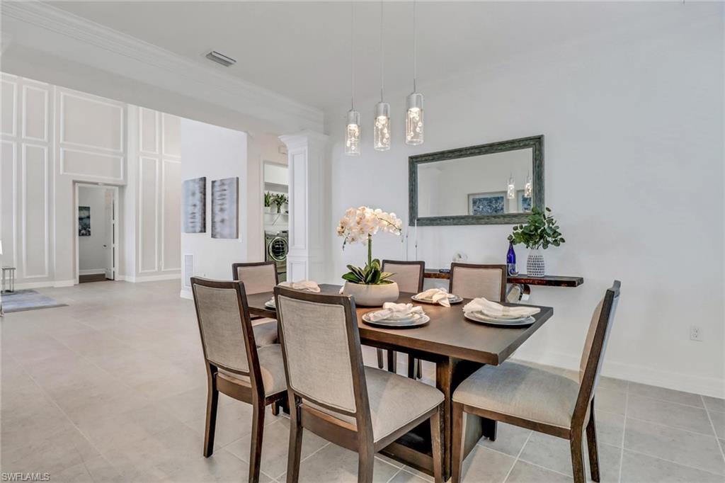 3260 Atlantic Circle Naples, FL 34119 - Photo 9 of 50 a view of a dining room with furniture