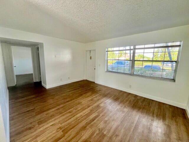3440 Rudolph Road, Unit 4 Lake Worth, FL 33461 - Photo 2 of 9 wooden floor in an empty room with a window